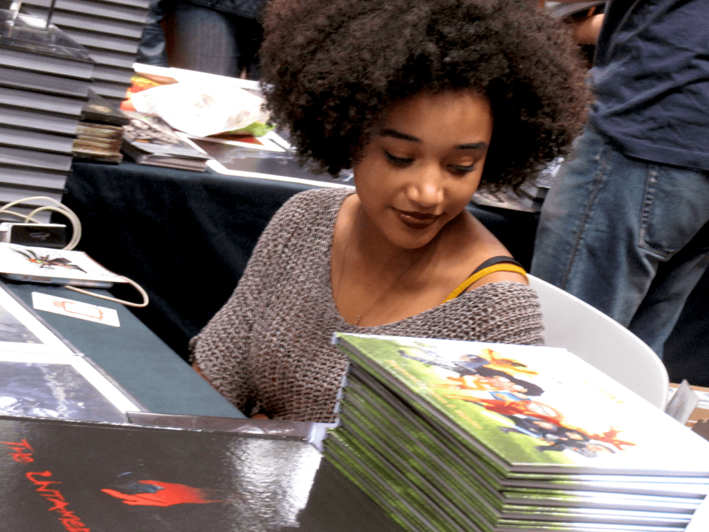 Amandla Stenberg signs copies of her YA comic NIOBE at New York Comic Con in 2015.